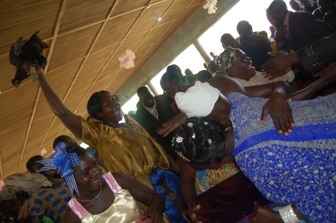 Family members gleefully presenting gifts.