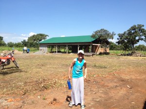 Avery in front of her families new home being built.